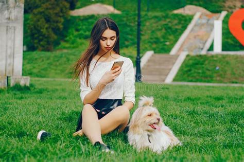 The Girl Walks In The Park With Her Dog Stock Image Image Of Grass
