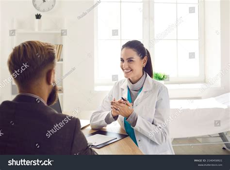 Smiling Female Doctor Consult Male Patient Stock Photo 2140458921
