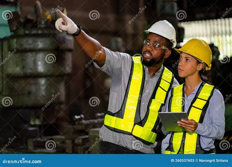 African American Factory Worker Discuss With His Coworker And Point