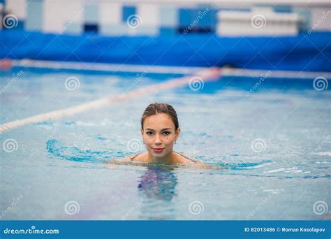 Smiling Portrait Of Beautiful Woman In Swimming Pool Stock Photo