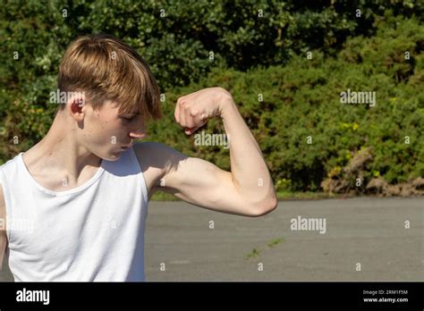 Fit And Sporty Teenage Boy Flexing His Bicep Stock Photo Alamy
