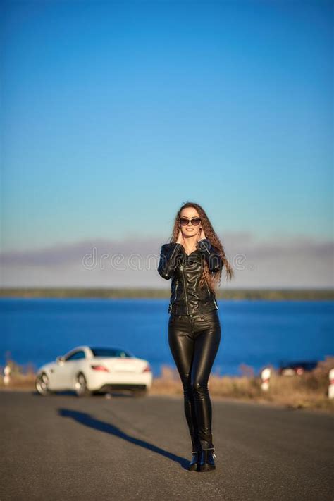 Beautiful Girl With Long Hair In A Leather Jacket And Leather Pants In