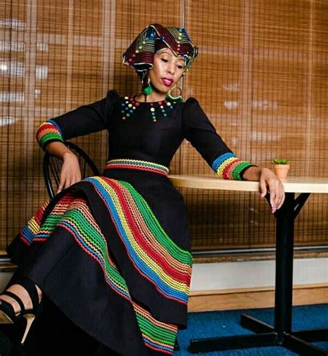 zandi in black flare umbhaco dress with colourful embroidery patterns crowned with colourful