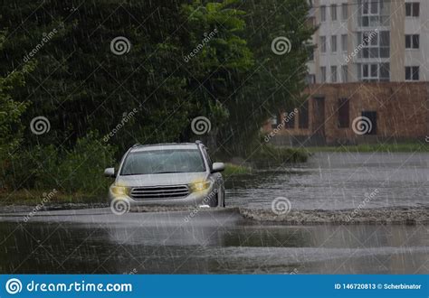 red car rides in heavy rain on a flooded road stock image image of reflection blurred 146720813