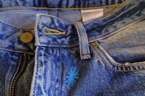 Blue Jeans With Zipper Pocket Metal Button Jeans Details Close Up
