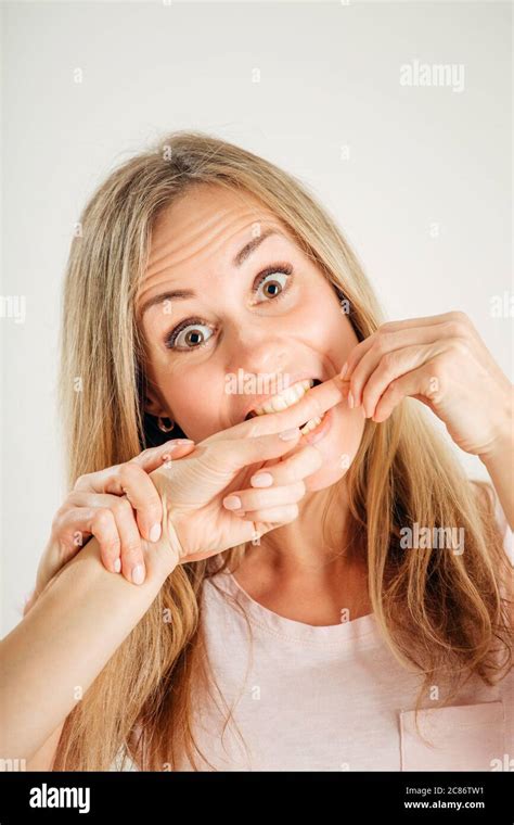 Closeup Portrait Picture Of Woman Biting Finger Of Her Sister Stock