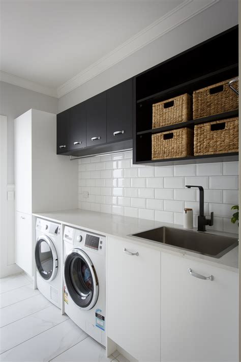 Placing your laundry center in the kitchen makes it simple to blend your laundry area with your kitchen by hiding it behind a set of doors. Reno Rumble 2016 - Week Five Kitchen Revealed > Caesarstone