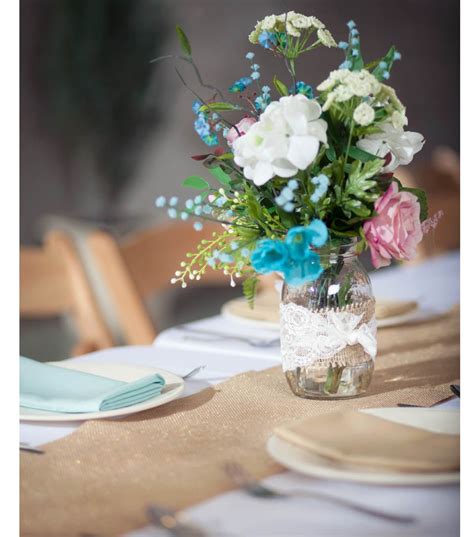 Burlap And Lace Wrapped Floral Centerpiece At Wedding