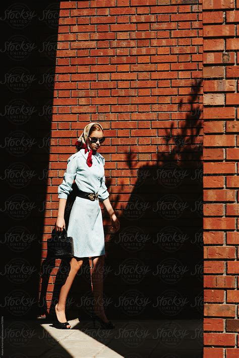 Blonde Girl Posing Against Brick Walls By Stocksy Contributor Atakan