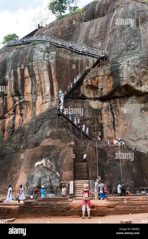 Visitors Climbing The Steep Stairs To The Rock Fortress Of Sigiriya
