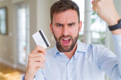 Handsome Business Man Holding Credit Card Annoyed And Frustrated