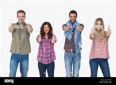 Fashionable Friends Looking At Camera And Giving Thumbs Up Stock Photo