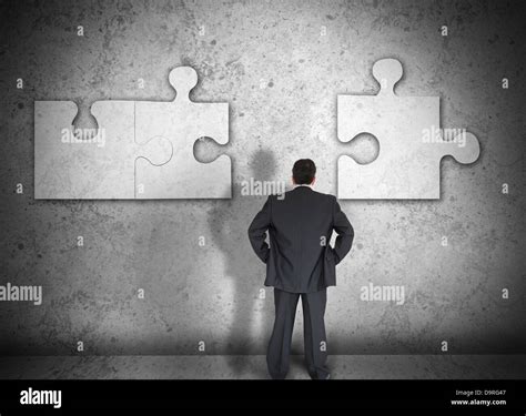 Businessman Figuring Out Puzzle Pieces Stock Photo Alamy