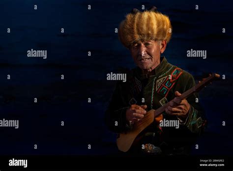 Local Man Playing Traditional Kyrgyz Musical Instrument Known As Komuz