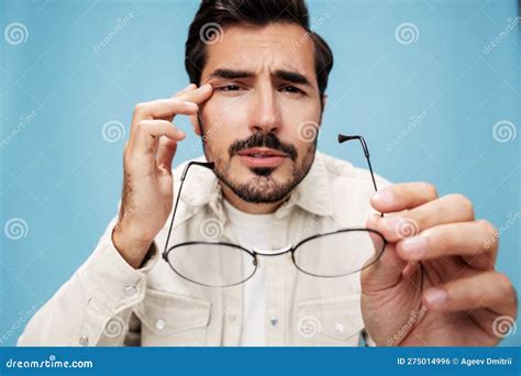 Close Up Portrait Of A Man Looking Through Glasses That He Holds In His Hands Dioptric Lenses