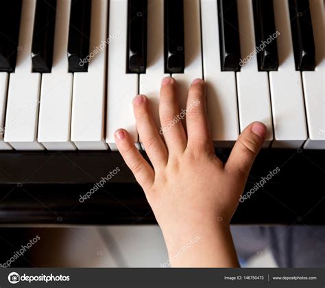 Childs Hands Playing Piano — Stock Photo © Maxoidos 146750473