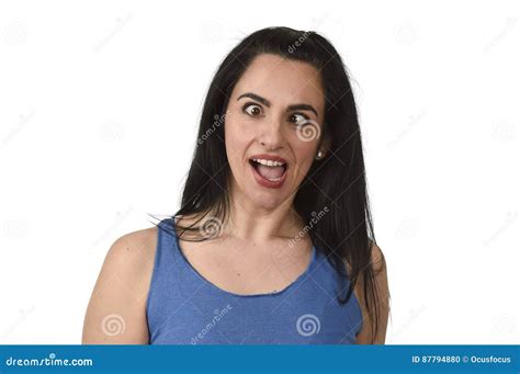 Young Attractive And Playful Woman Sticking Out Tongue And Crossing Eyes Looking Crazy Stock
