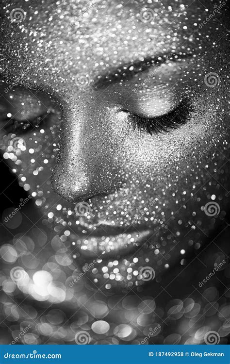 Portrait Of Beautiful Woman With Sparkles On Her Face Stock Photo