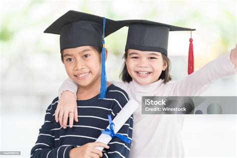 Graduation Concept With Two Happy Southeast Asian Friend Schoolgirls With Certificates In