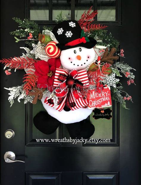 A Christmas Wreath With A Snowman On The Front Door