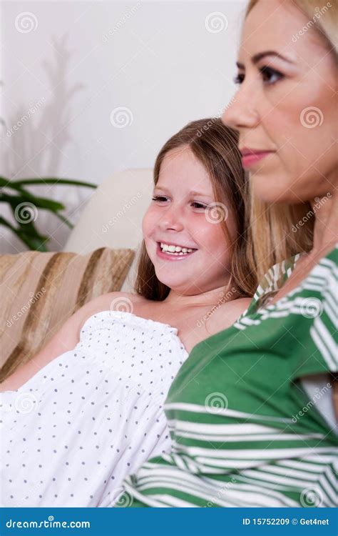 Mother And Daughter Sitting Together On Couch Stock Image Image Of