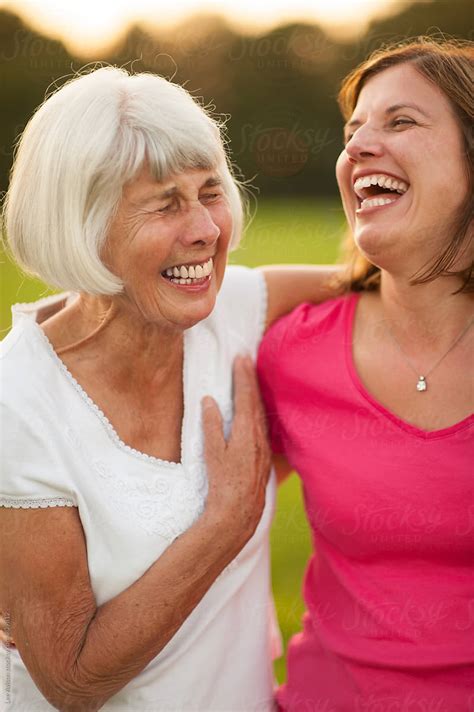 Senior Mother And Mature Daughter Laughing And Hugging By Lee Avison