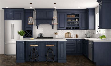 Blue perimeter cabinets, also topped with a marble countertop, are fitted with a farmhouse sink located under windows facing a blue wood paneled refrigerator. CNC Concord Park Ave Ocean Blue Kitchen Cabinets Low Price