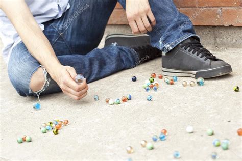 A Boy Playing Marbles On The Street — Stock Photo © Kozzi2 19875971
