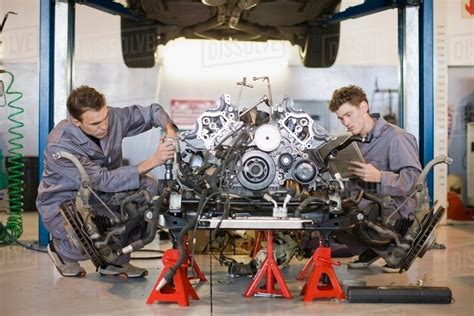 Mechanics Working On Car Engine Stock Photo Dissolve