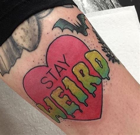A Tattoo With The Word Stay Weird On Its Arm And An Image Of A Heart