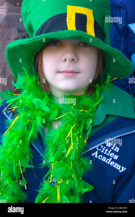 st patrick s day parade girl age 8 wearing green irish boa and top hat st paul minnesota usa