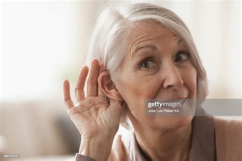 Senior Caucasian Woman Cupping Her Ear To Listen High Res Stock Photo