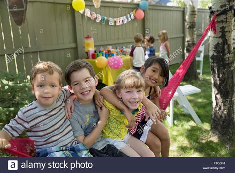 Portrait Smiling Kids Hammock Backyard Birthday Party Stock Photo Alamy