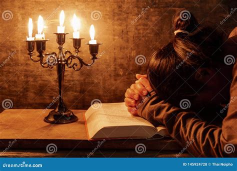 Woman Praying Hands Clasped Together On Her Bible Stock Photo Image
