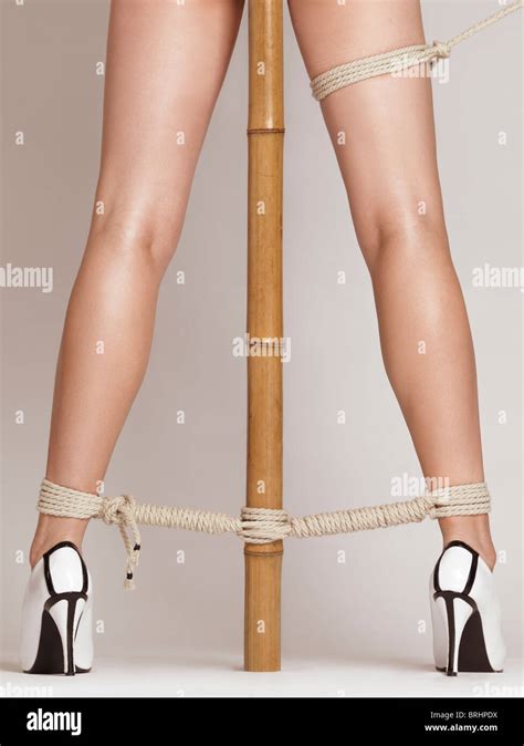 Sexy Woman Legs Tied With Bondage Ropes To A Bamboo Pole Stock Photo Alamy