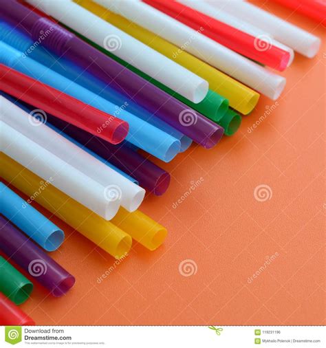 Many Colorful Straws For Drinks Lies On A Bright Orange Backgrou Stock
