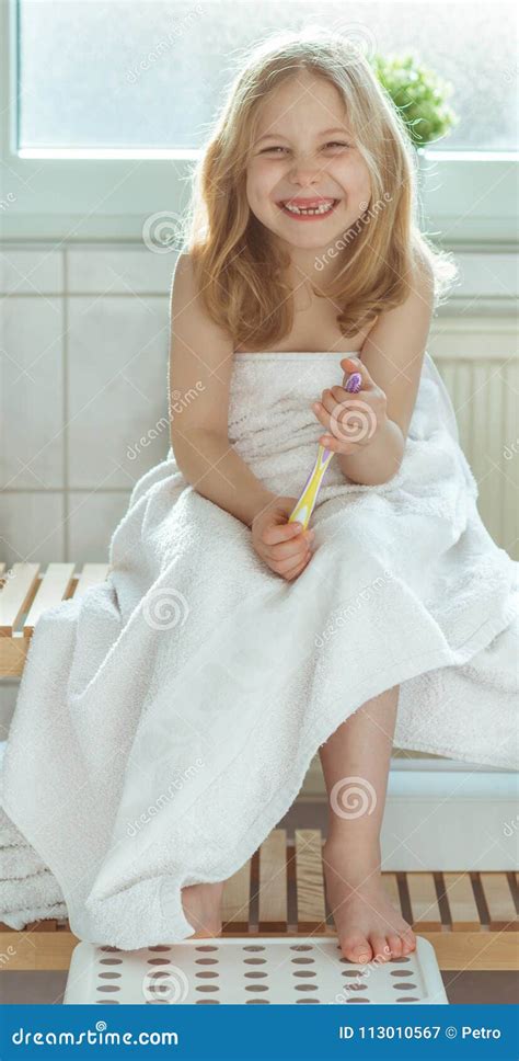 Portrait Of Pretty Little Child Girl With White Towel After Show Stock