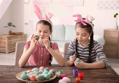 Cute Little Girls Painting Eggs For Easter At Table Stock Image Image