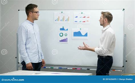 Colleagues Managers Discussing Diagrams And Graphs Work In The Office