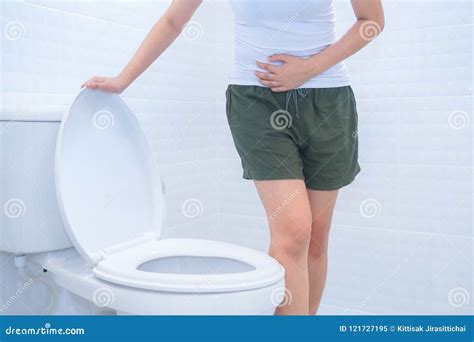A Woman Is Sitting On Toilet With Diarrhea Or Constipated Pain C Stock