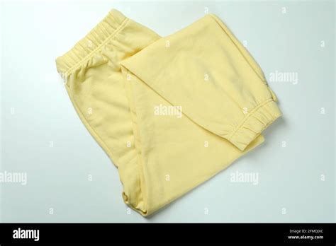 Folded Yellow Sweatpants On White Background Top View Stock Photo Alamy