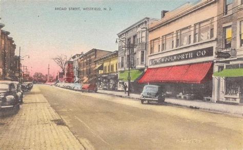 An Old Postcard Shows Cars Parked On The Street