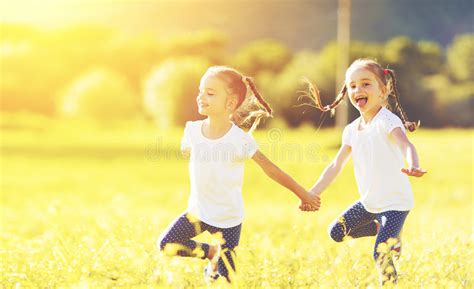 Happy Children Twins Sisters Run And Play Outdoors Stock Photo Image