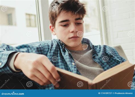 Teenage Boy Reading Or Studying At Home Stock Image Image Of Light