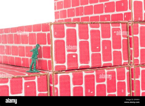 Green Army Man Banging Head Against A Brick Wall Stock Photo Alamy