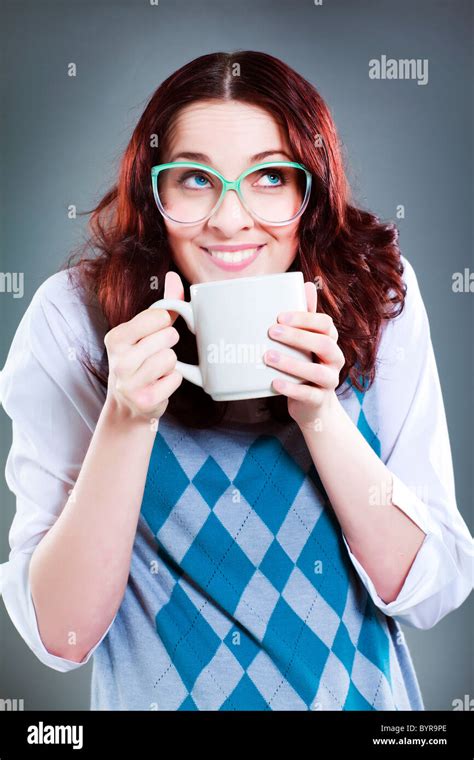 Geeky Woman Looks Up To The Side Whilst Holding A Blank White Mug Stock