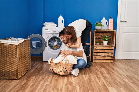 Man And Woman Couple Hugging Each Other Washing Clothes At Laundry Room Stock Image Image Of