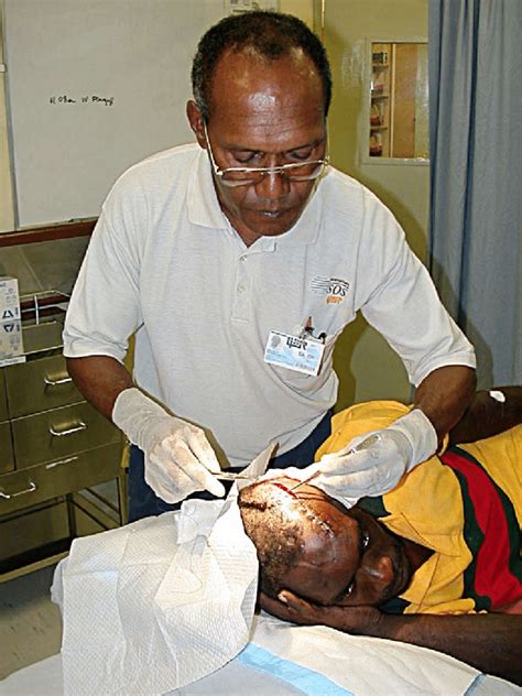 Dr Vui Mea Stitches A Head Wound At The New Hospital At Lihir