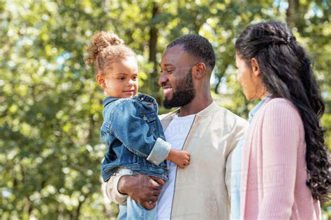 Portrait Of Happy African American Parents And Daughter Standing