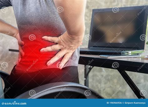 Woman Suffering From Office Syndrome Having Lower Back Pain Sitting On
